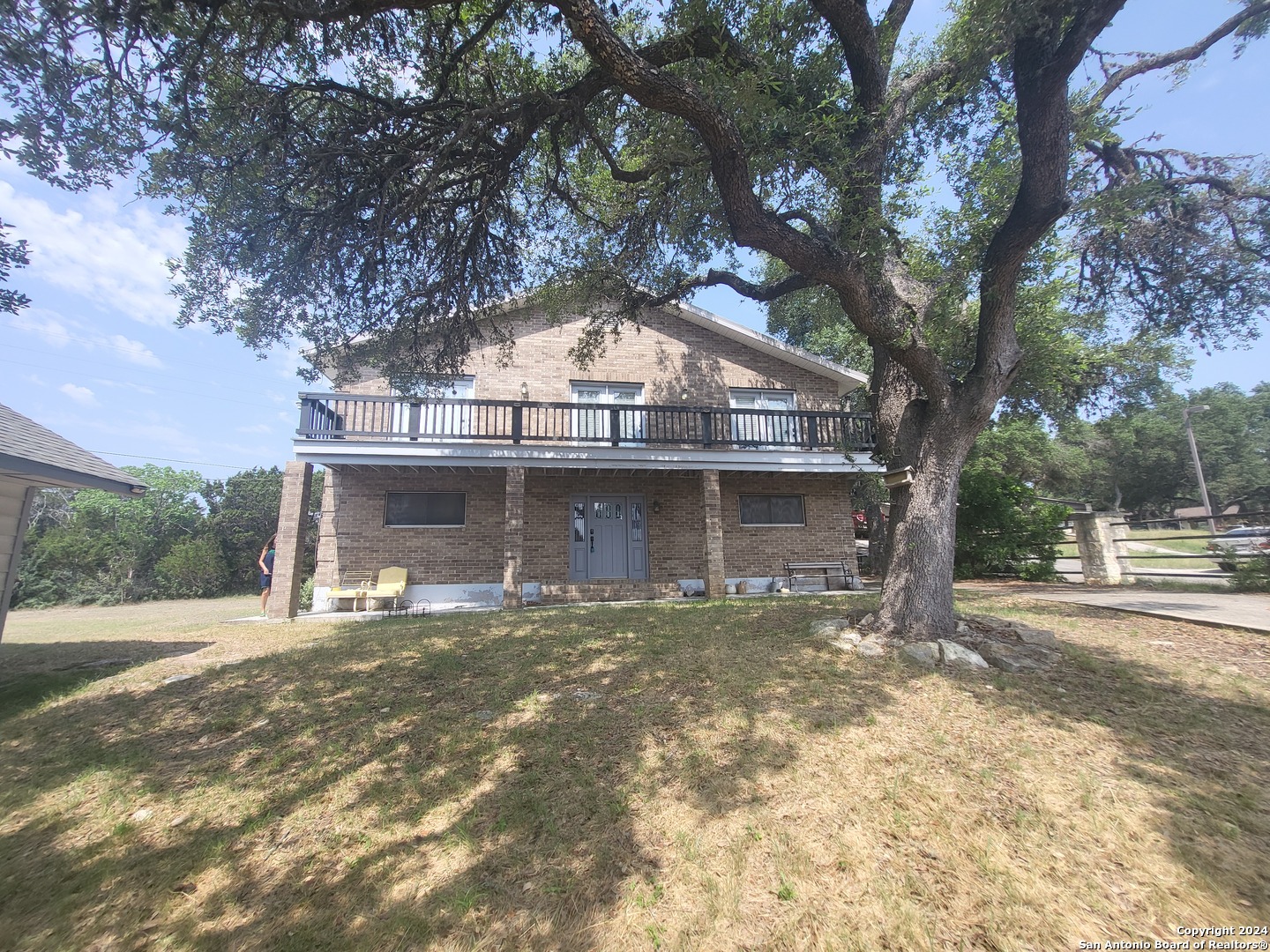 a large tree in front of a house