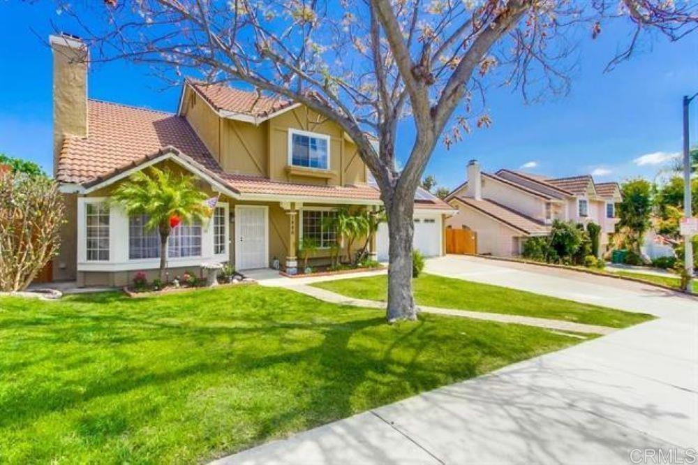 a view of a house with a yard and plants