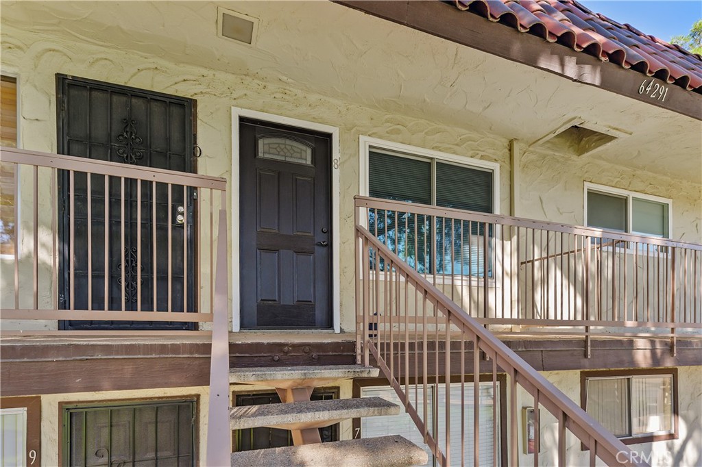 a view of staircase with railing and a window