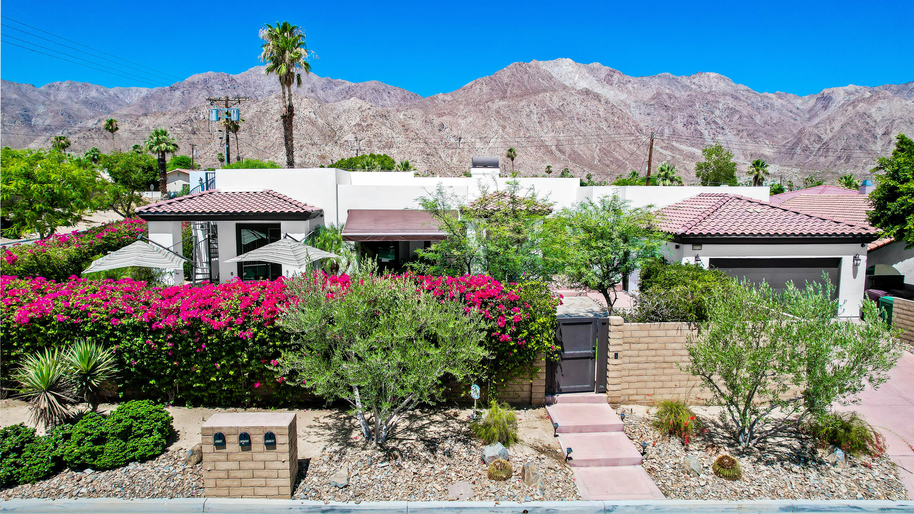 a view of a house with a yard and garden