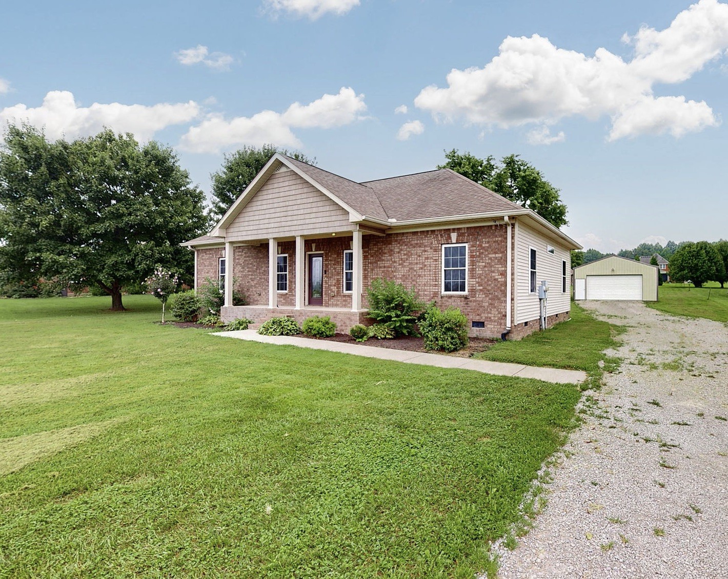 a front view of house with yard and green space