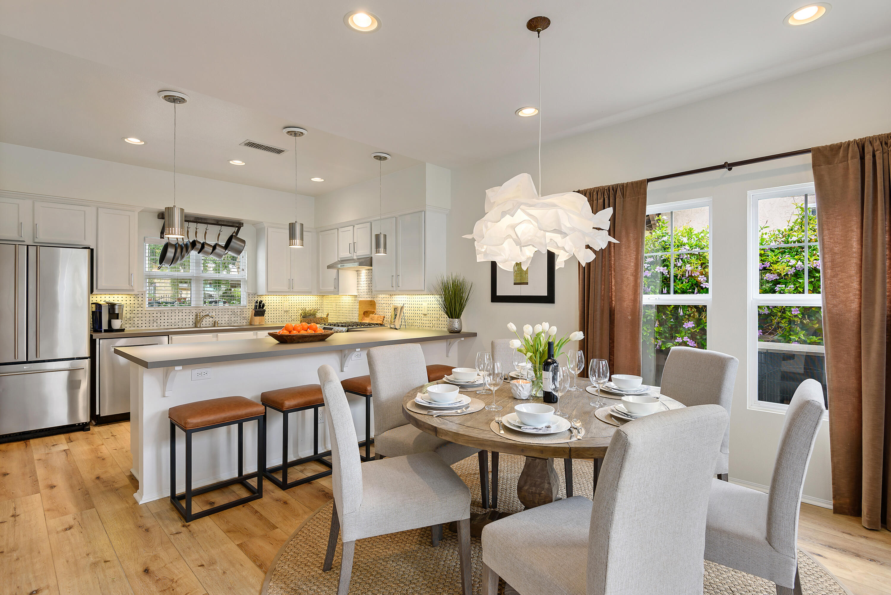 a kitchen with counter space dining table and stainless steel appliances