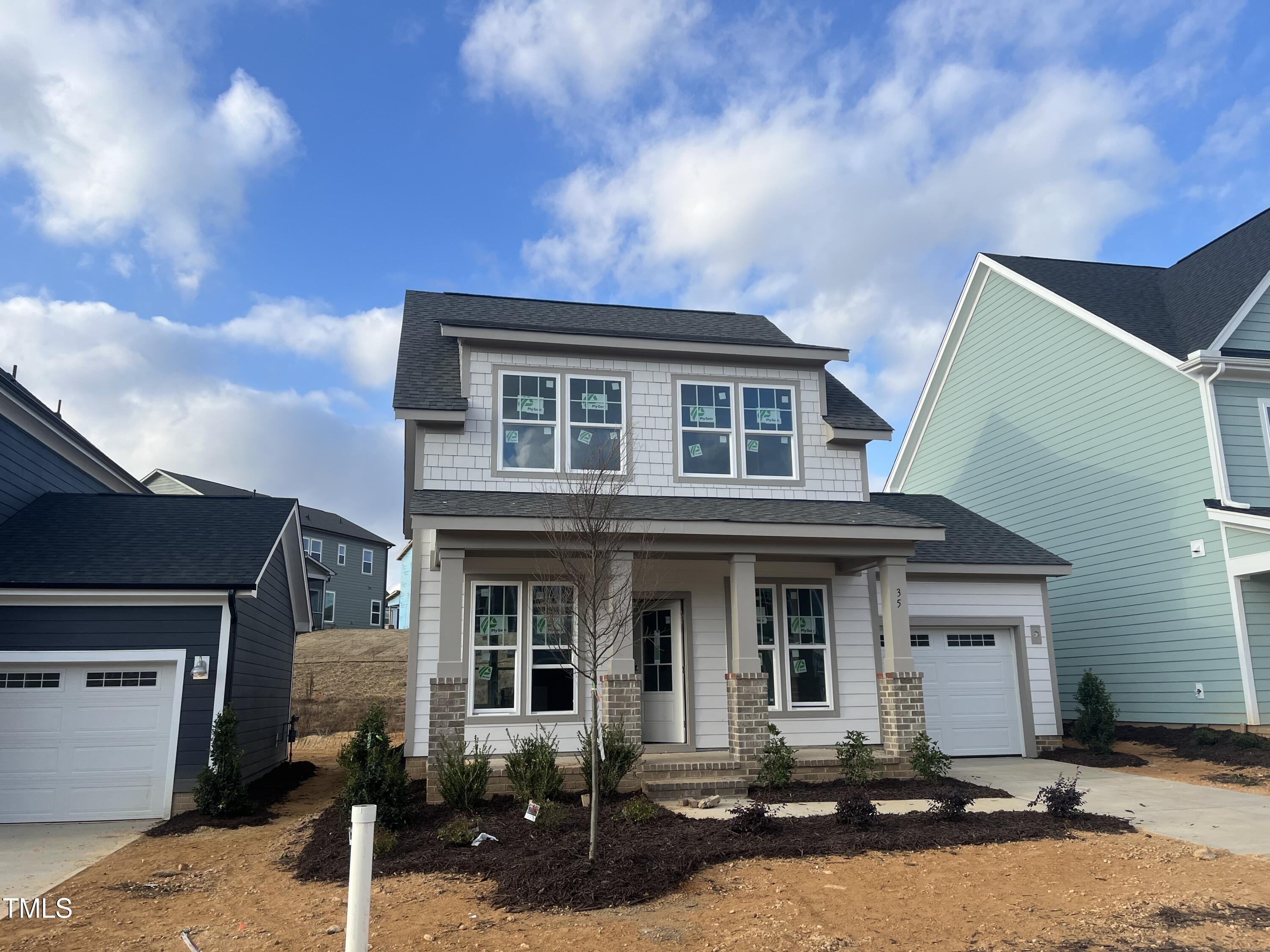 a front view of a house with yard and seating space