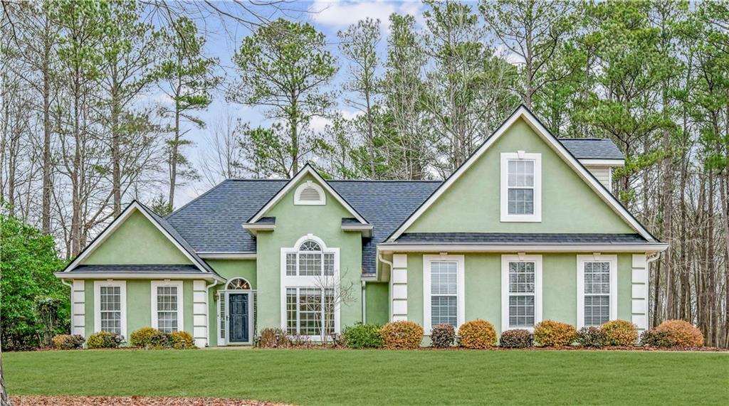 a front view of a house with a yard