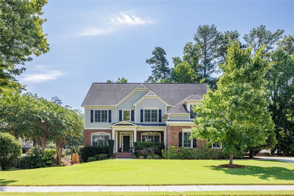 a front view of a house with a garden