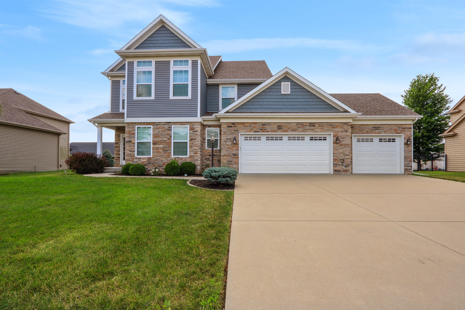 a front view of a house with a yard and garage