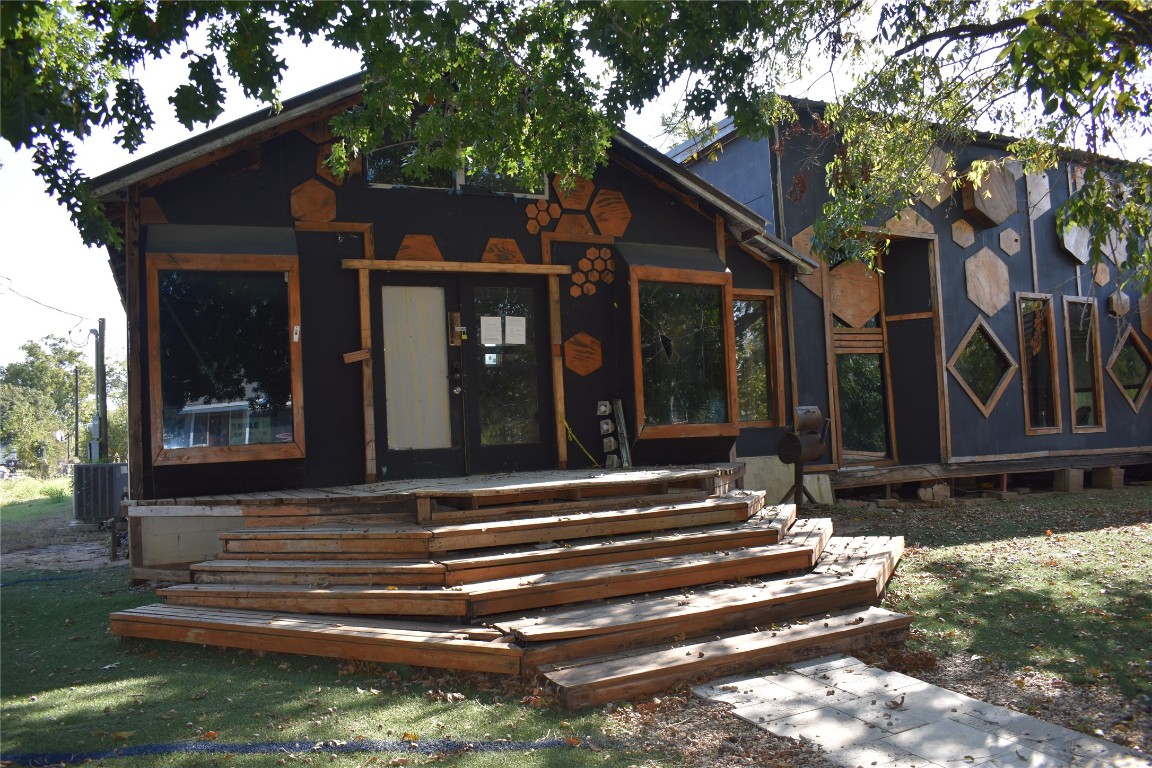 a view of a house with a large windows and a tree