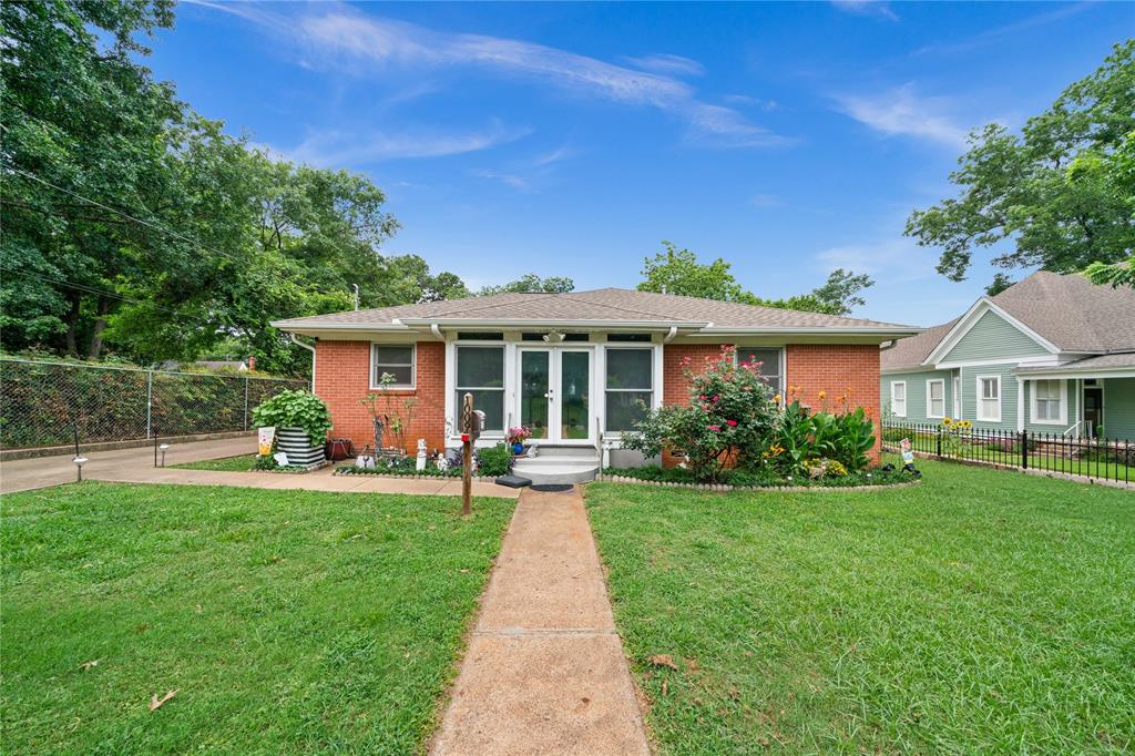 a front view of a house with a garden and porch