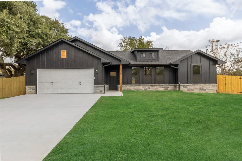 a front view of house with yard and green space