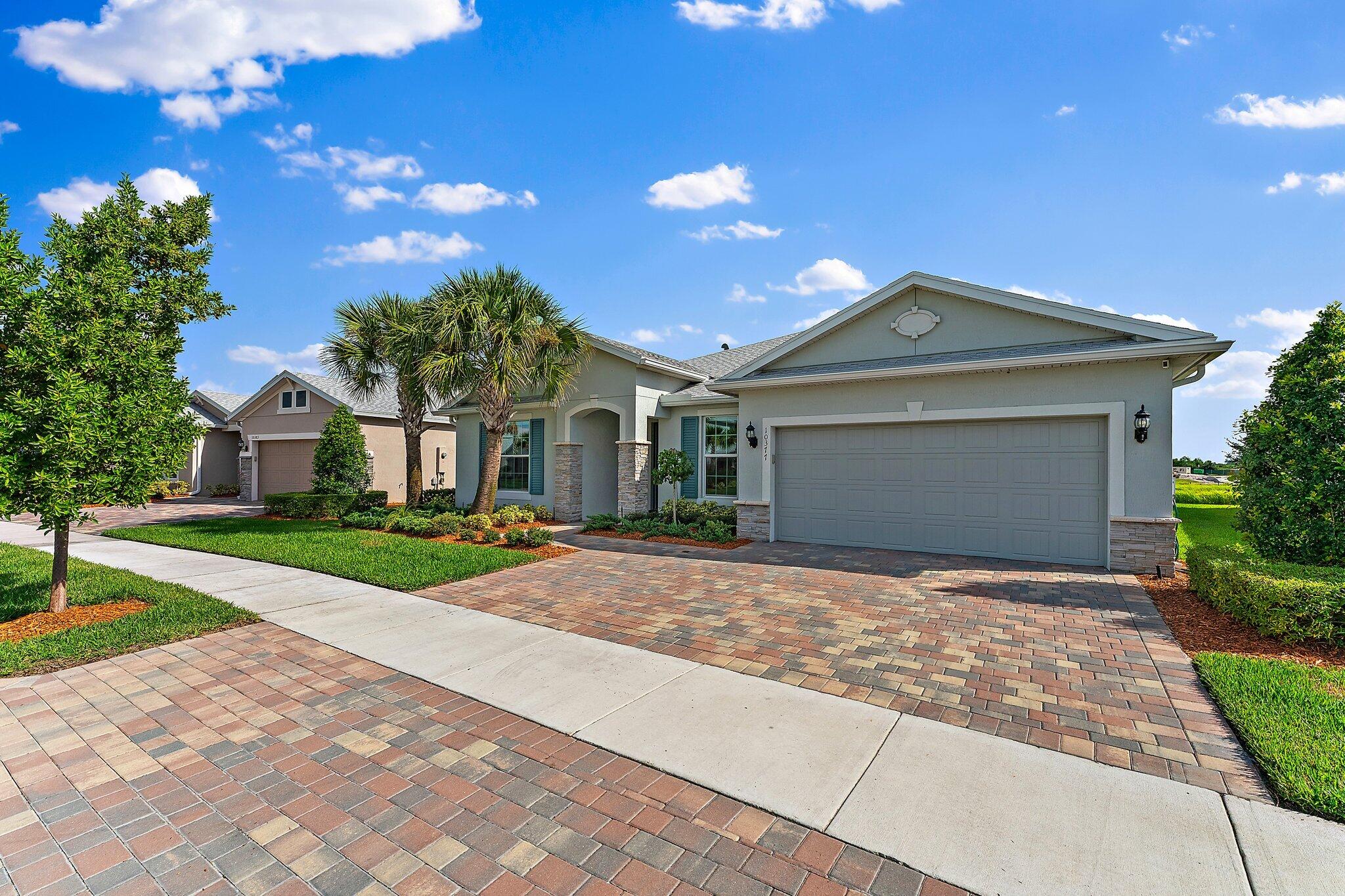 a front view of a house with a garden and yard