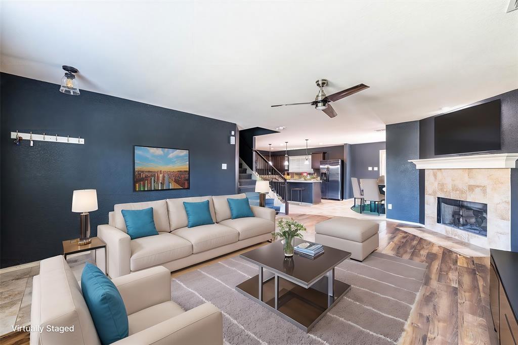 a living room with furniture a fireplace and a flat screen tv