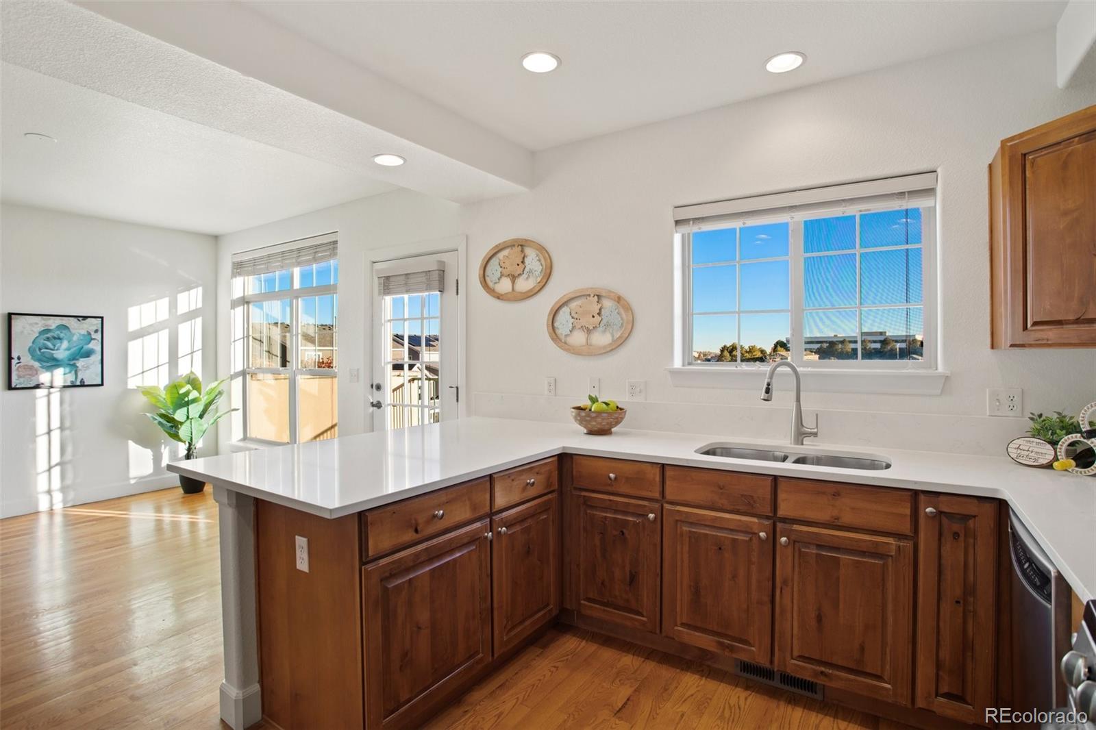 a kitchen with a sink cabinets and wooden floor