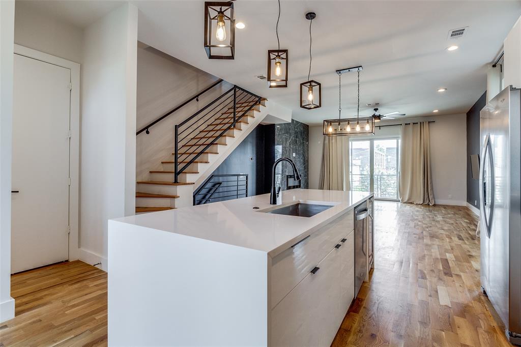 a view of a kitchen and wooden floor