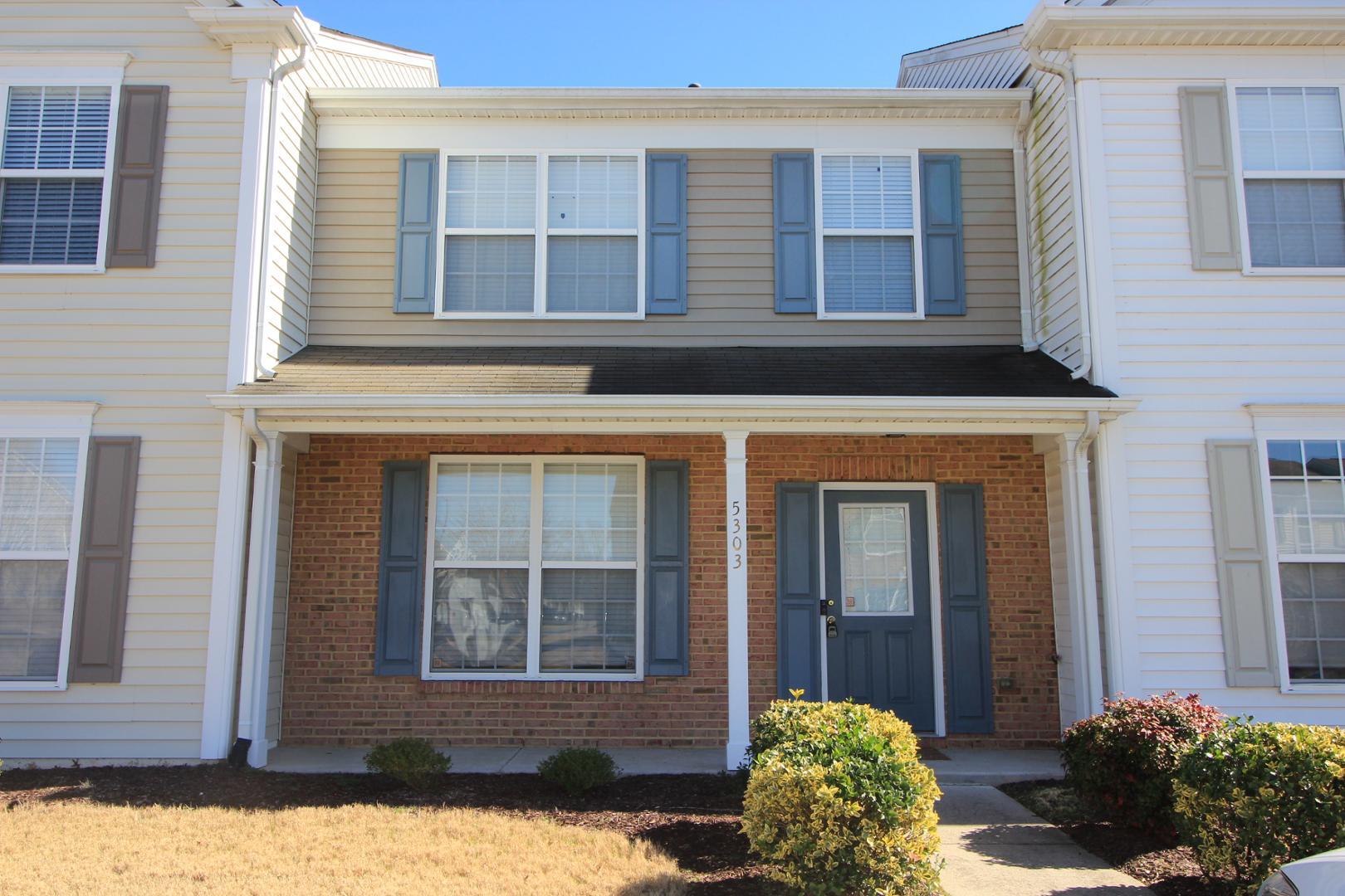 front view of a brick house with a outdoor space