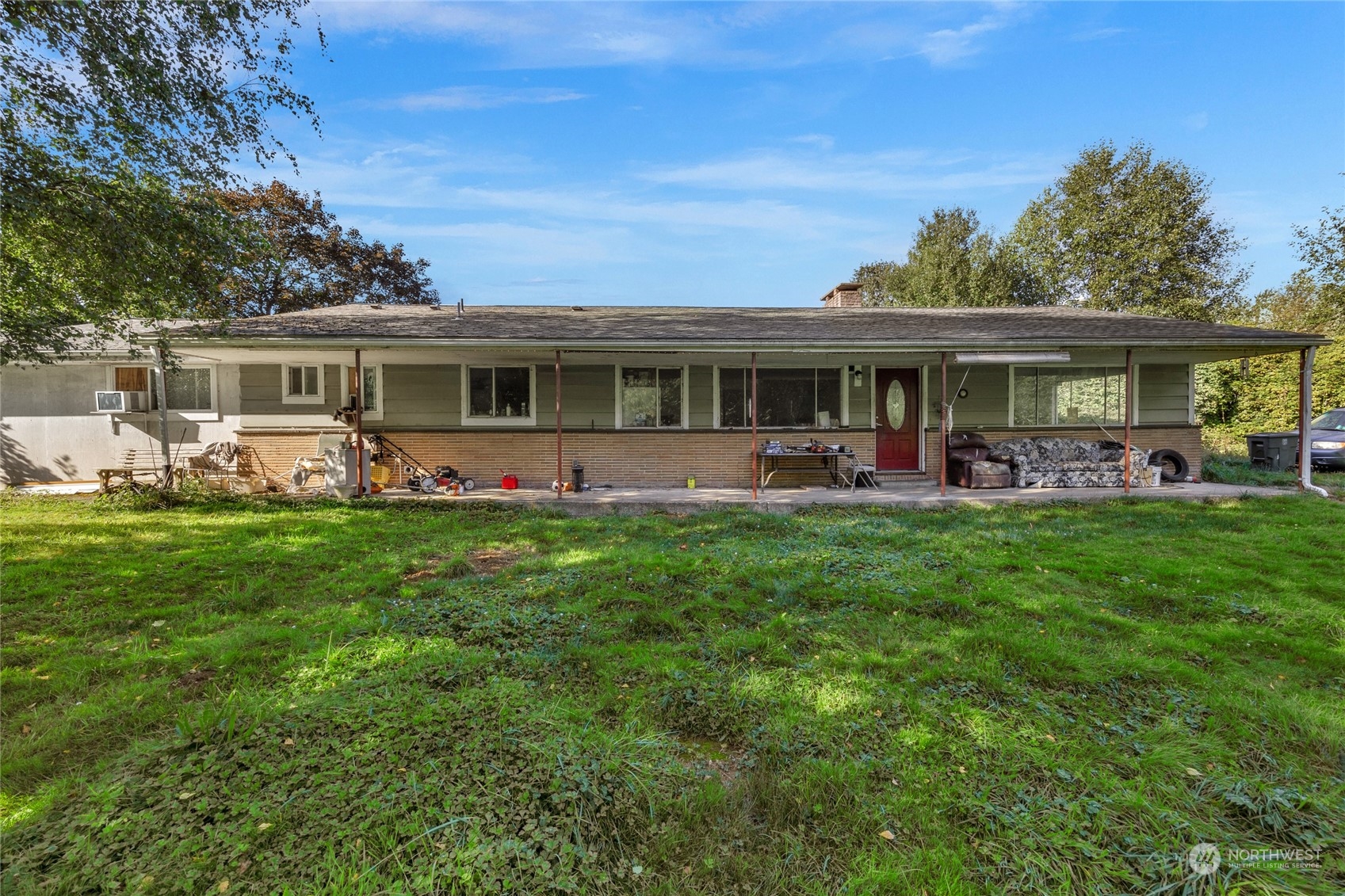 a front view of house with yard and outdoor seating