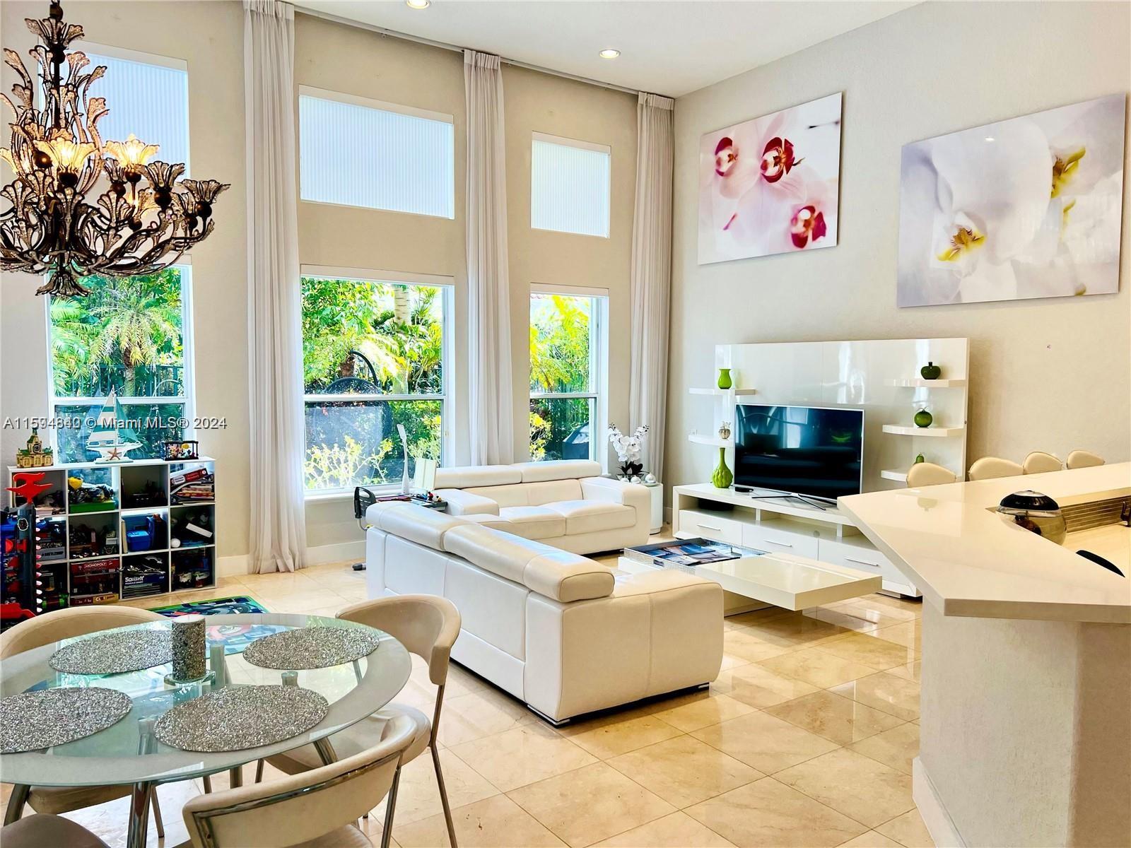 a living room with fireplace furniture and a large window