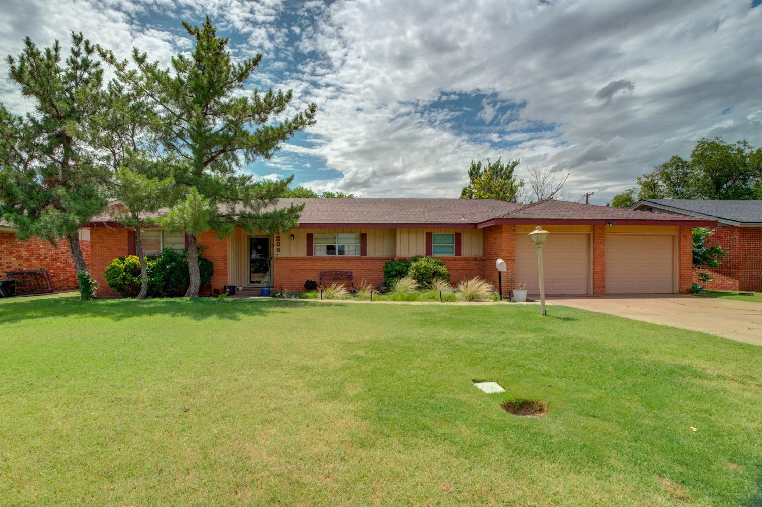 a front view of house with yard and green space