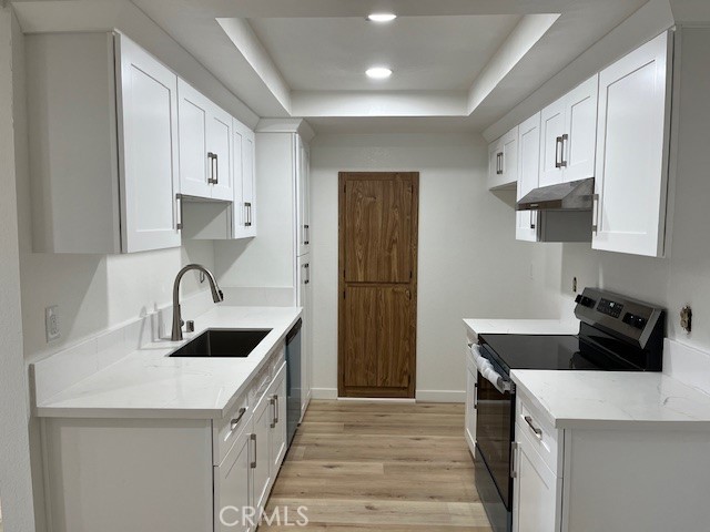 a kitchen with white cabinets and white appliances