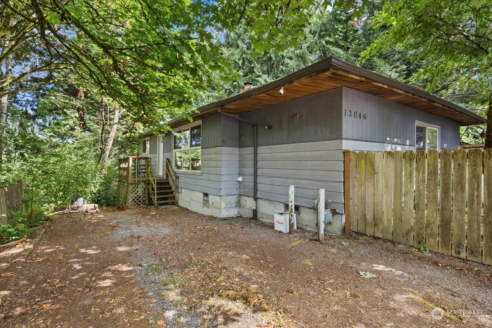 a backyard of a house with table and chairs