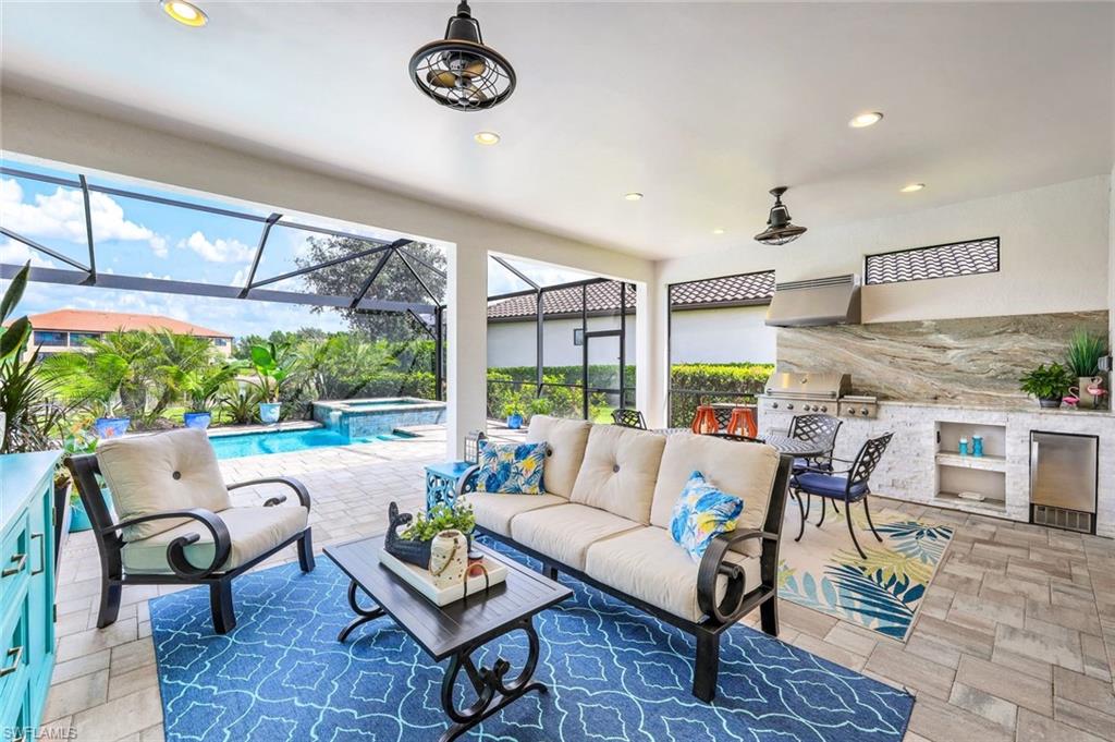 a living room with patio furniture and a large window