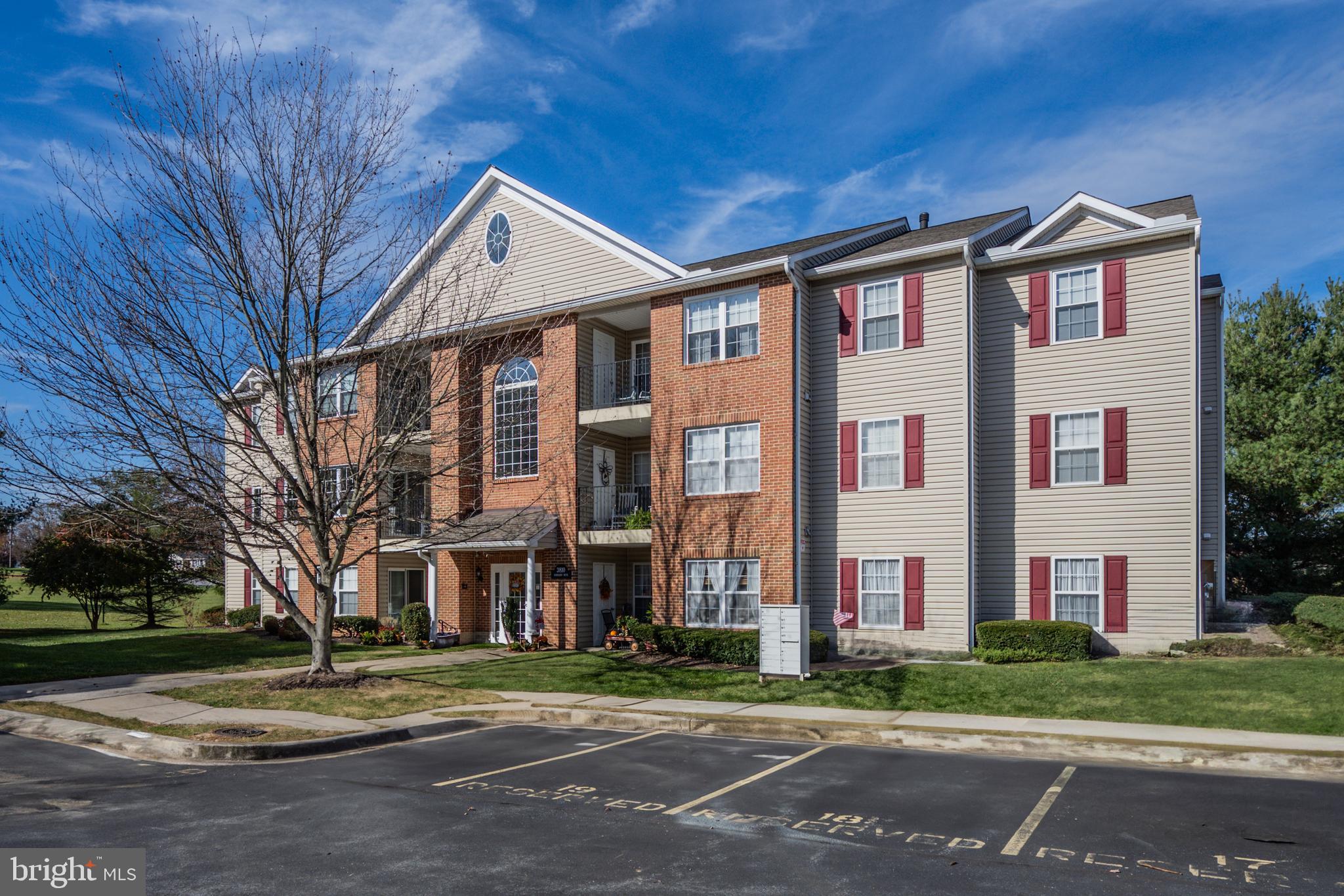 a front view of a residential apartment building with a yard