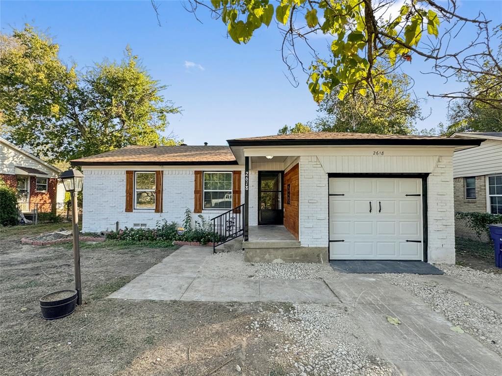 front view of a house with a wooden fence