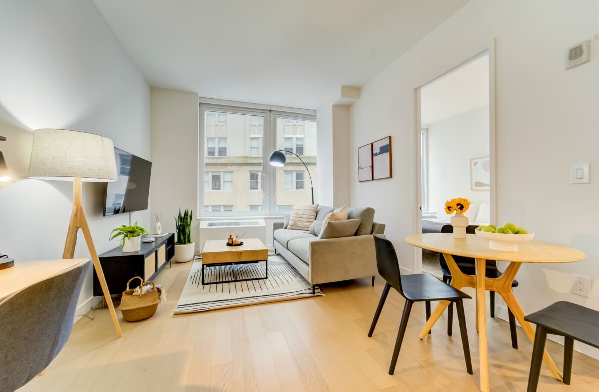 a living room with furniture a table and a lamp