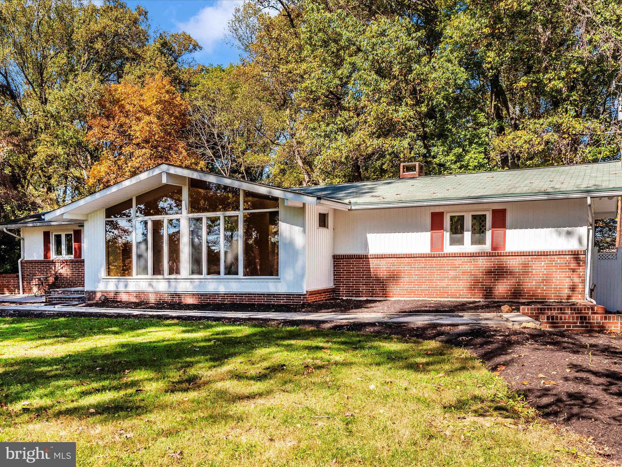 a front view of house with yard outdoor seating and barbeque oven