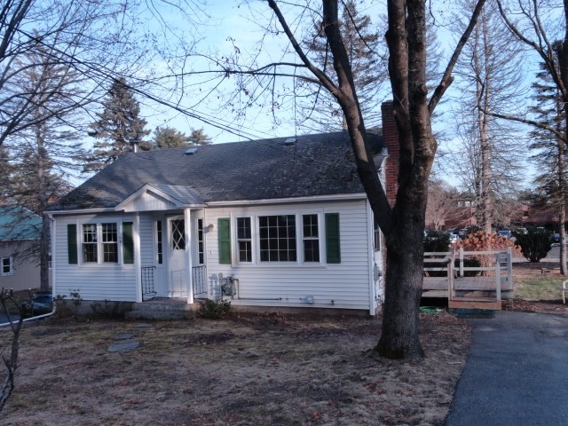 a house that has a tree in front of it