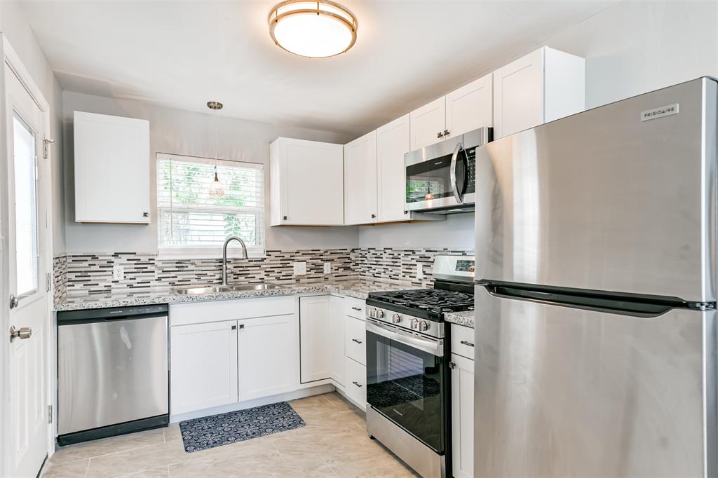 The kitchen features a gas-range stove, dishwasher and granite countertops.