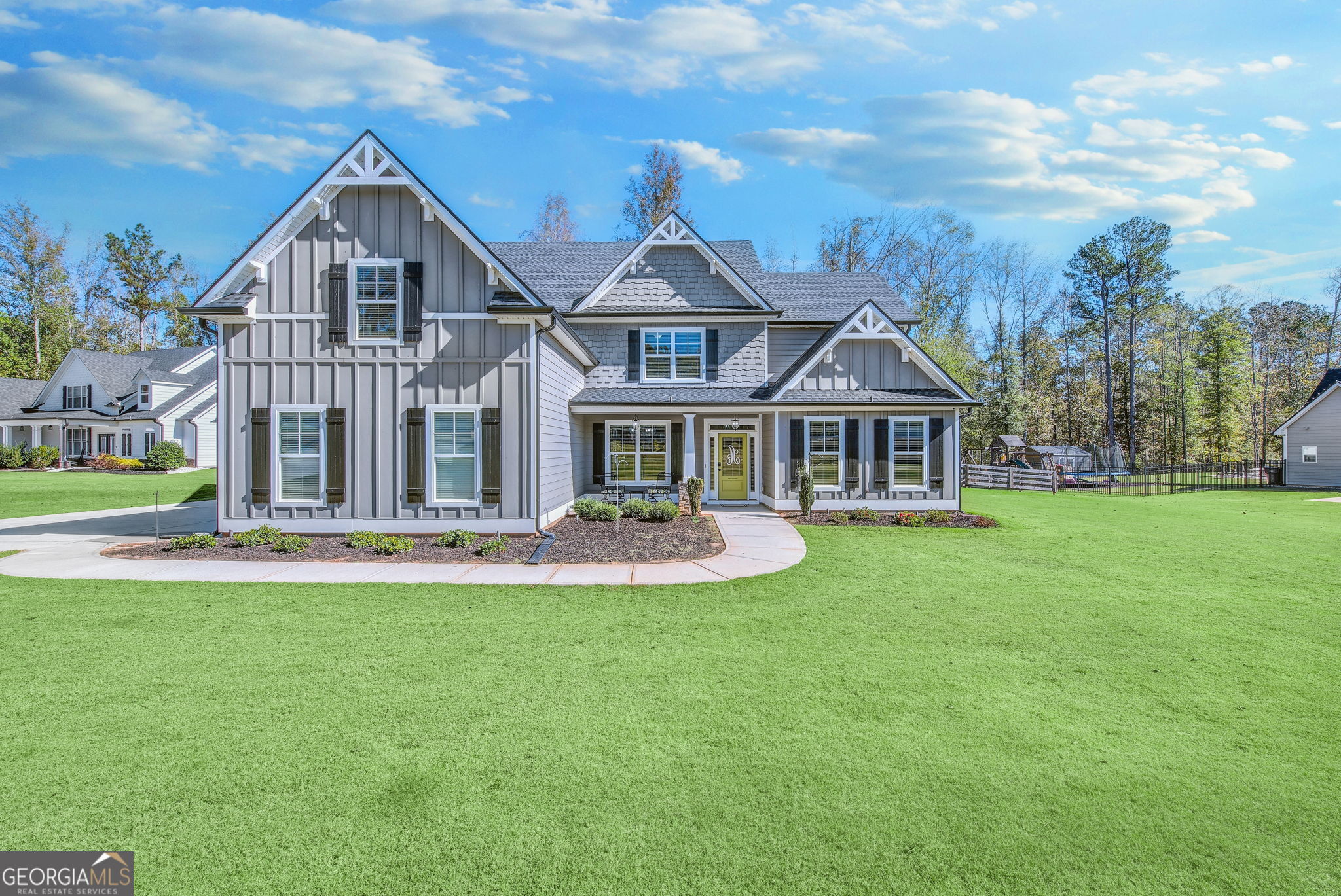 a front view of house with yard and green space