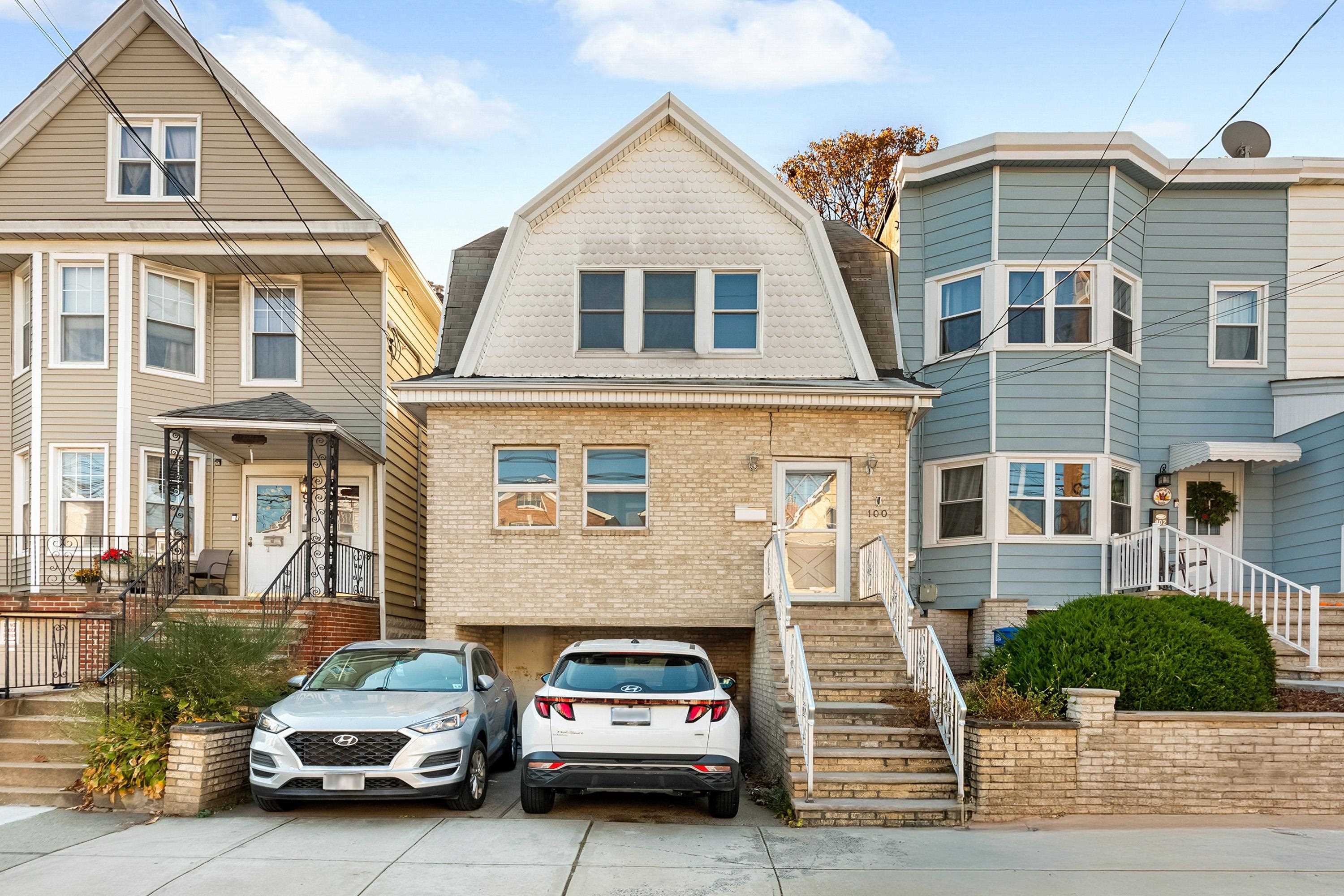 a car parked in front of a brick house