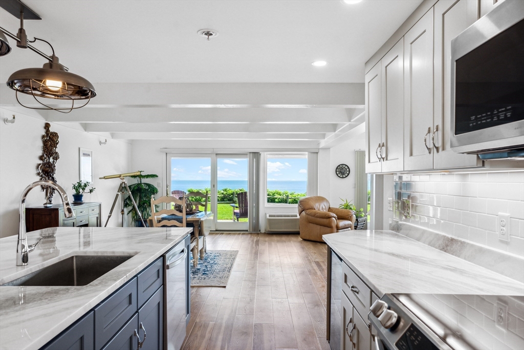 a kitchen with a stove a sink and a microwave