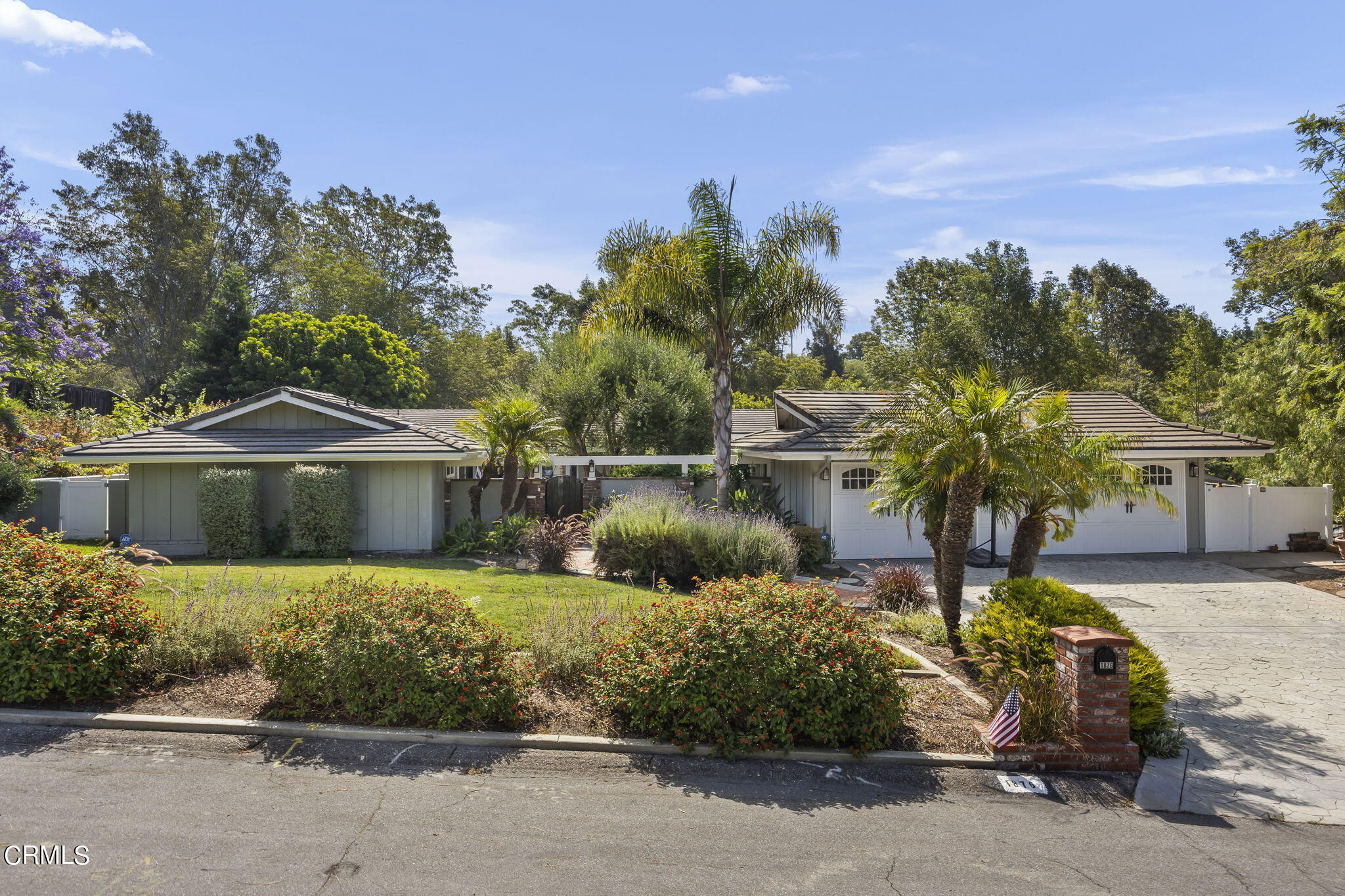 a front view of a house with a garden