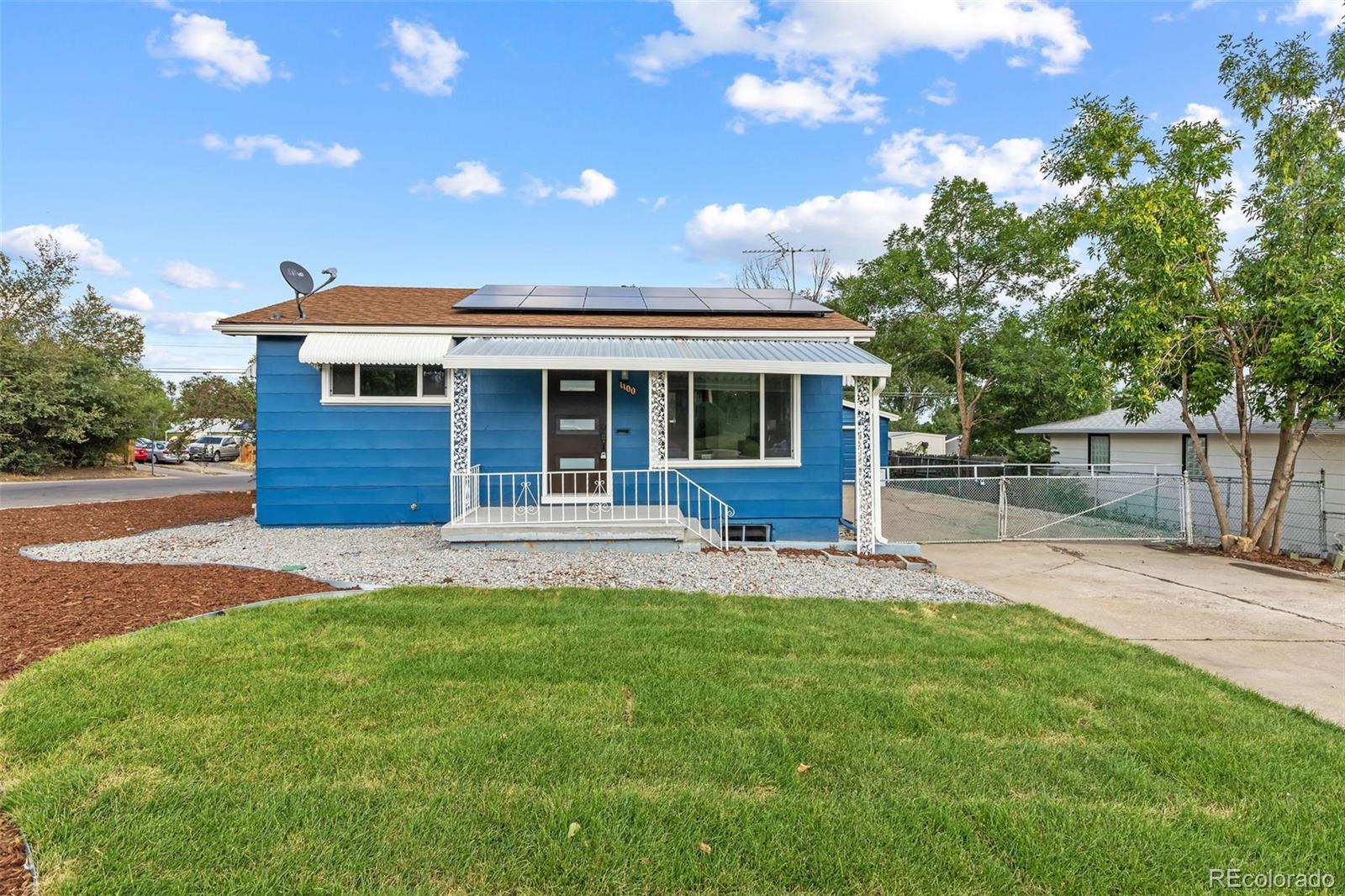 a view of a house with a yard and sitting area