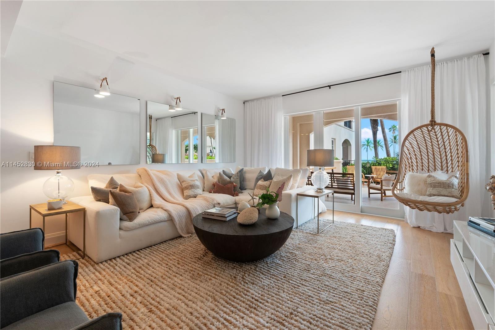 a living room with furniture a rug and a chandelier