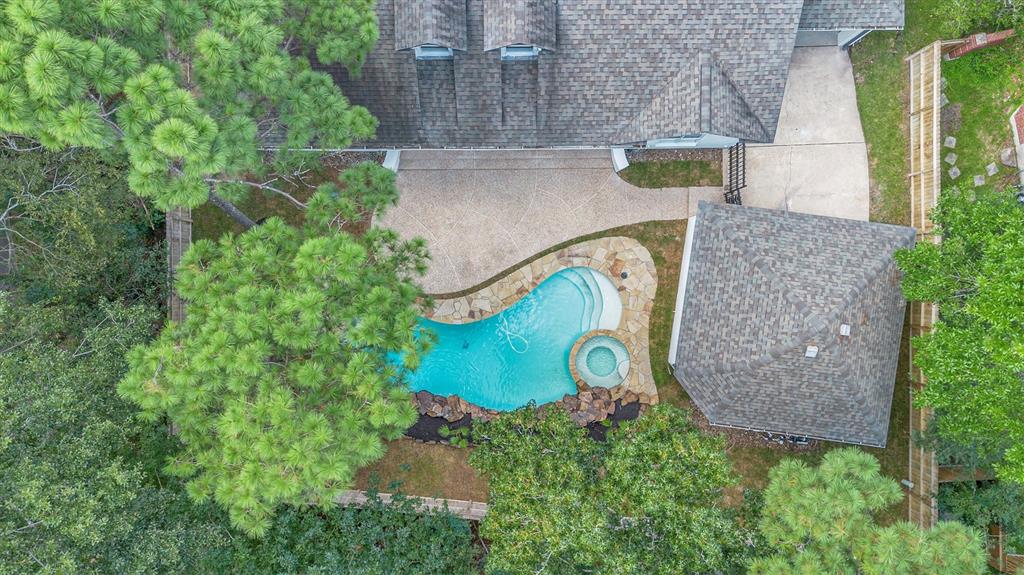 an aerial view of a house with garden space sitting space and swimming pool