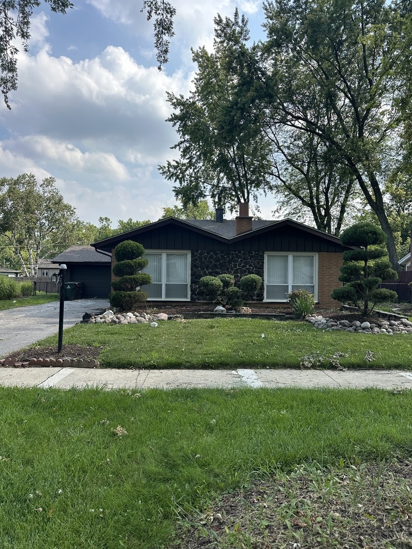 a front view of a house with a garden