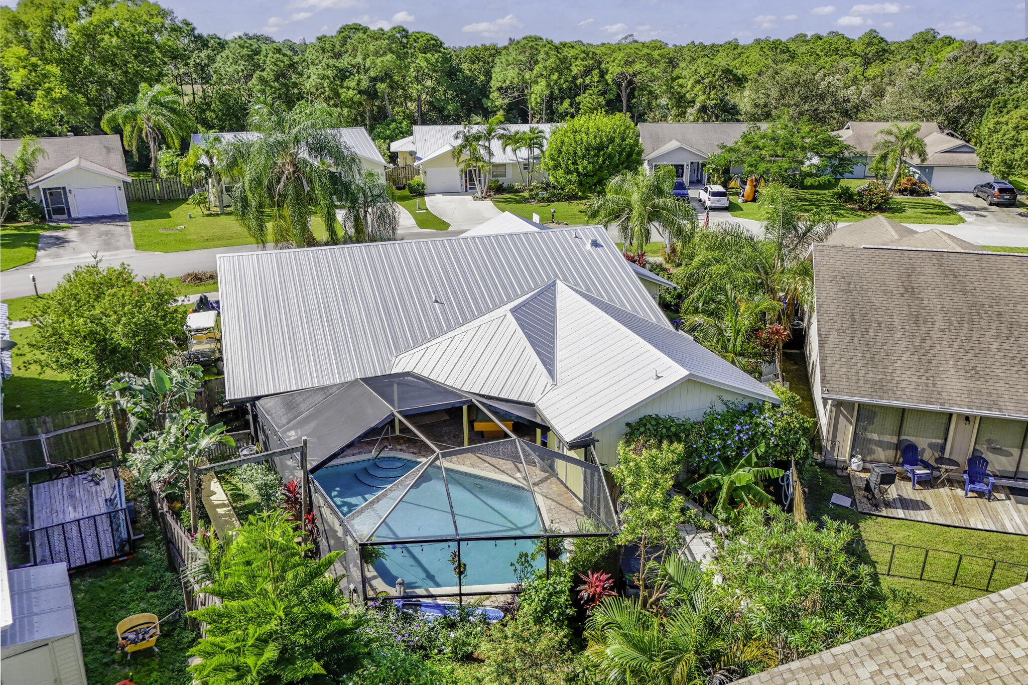 an aerial view of house with swimming pool and outdoor seating