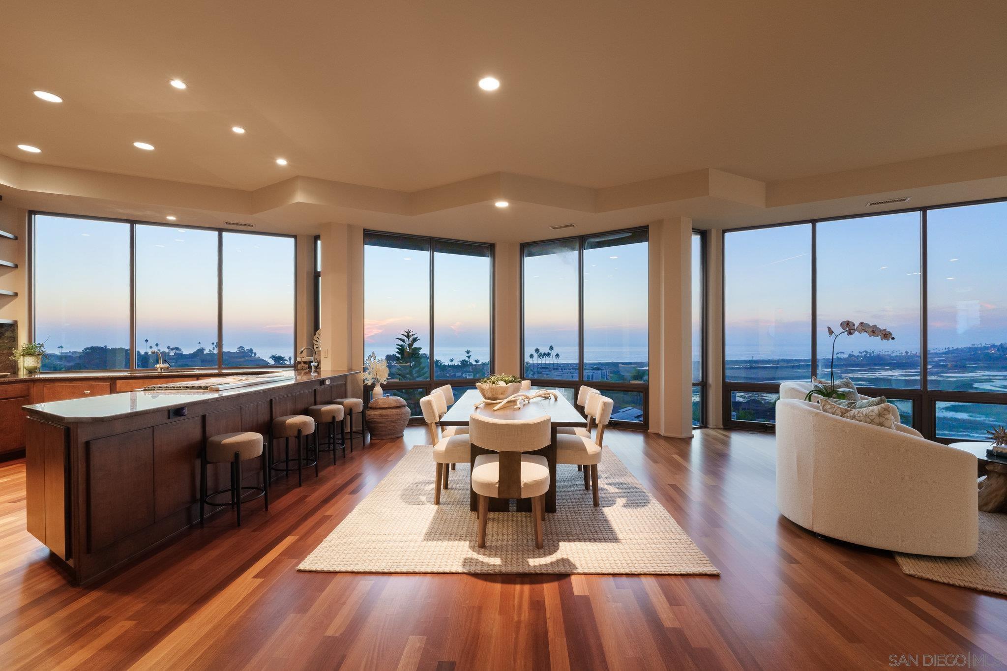 a living room with furniture and floor to ceiling windows