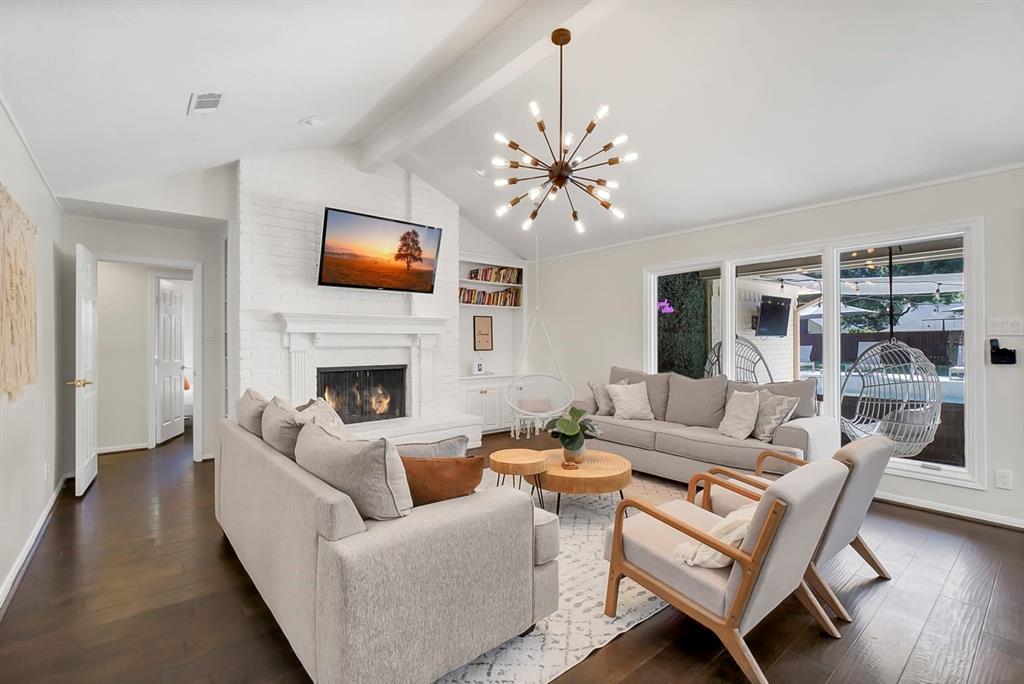 a living room with furniture a fireplace and a flat screen tv