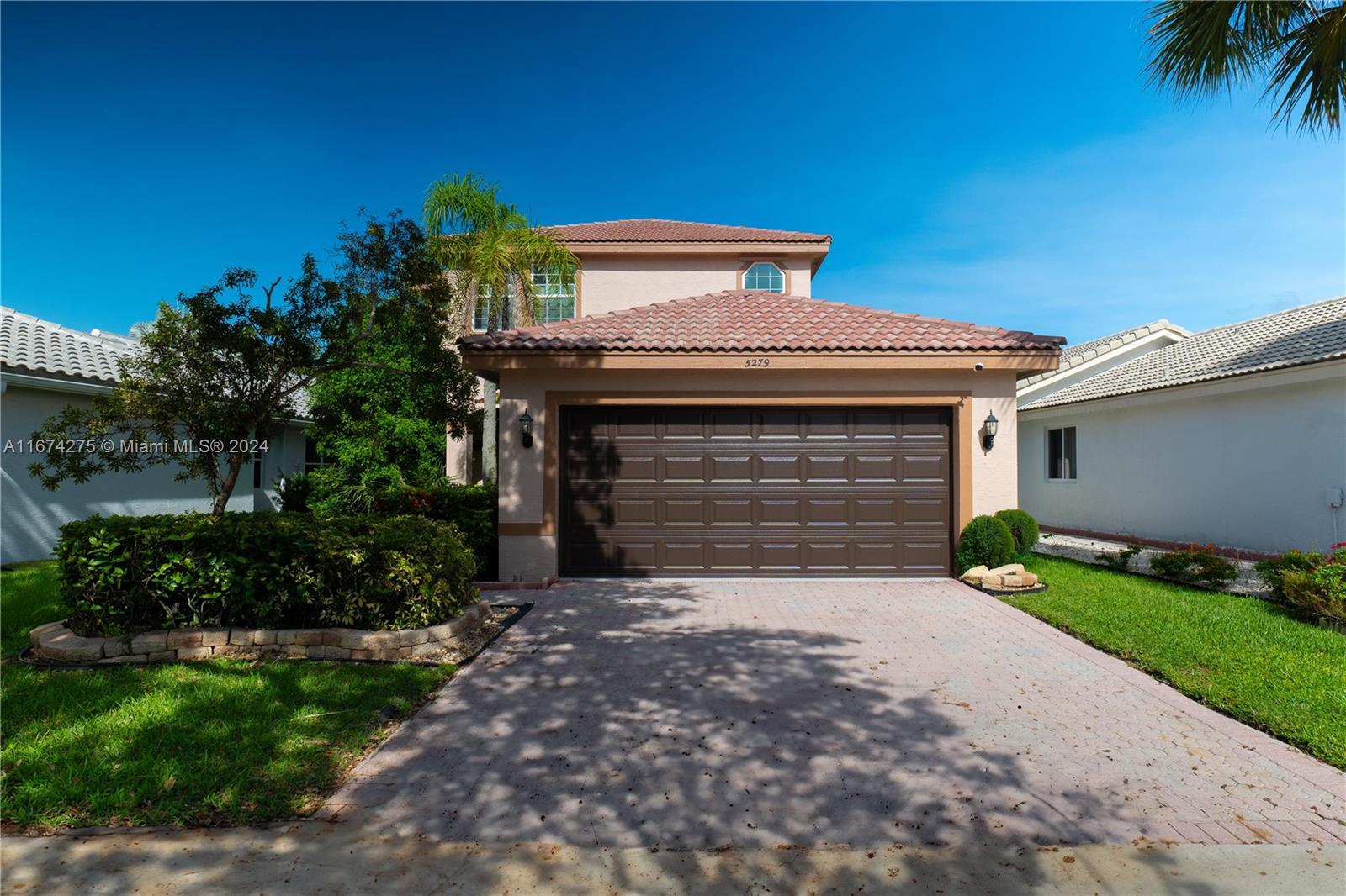 a front view of a house with a yard and garage