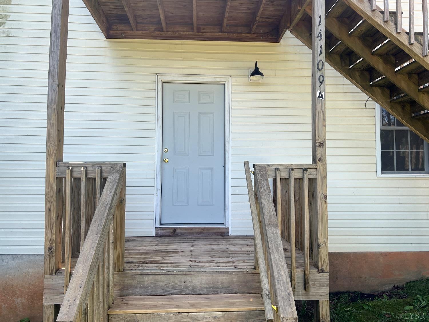 a view of a house with wooden deck