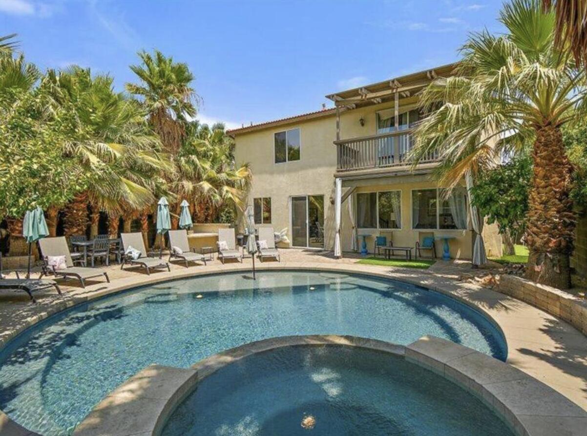 a view of a house with swimming pool and sitting area