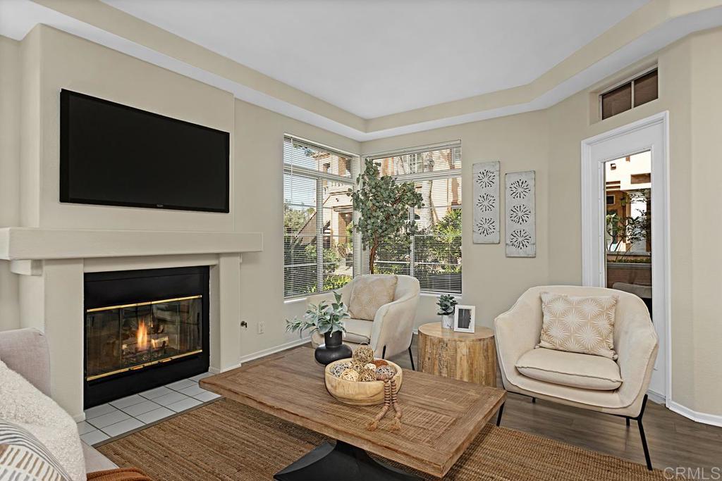 a living room with furniture a flat screen tv and a fireplace