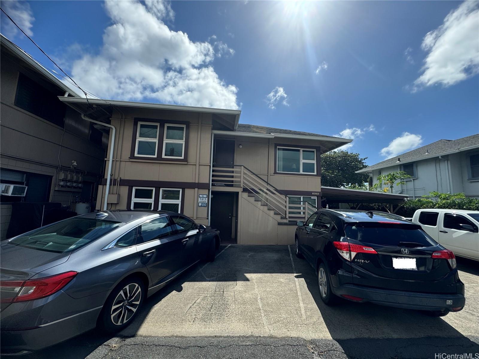 a front view of a house with parking space