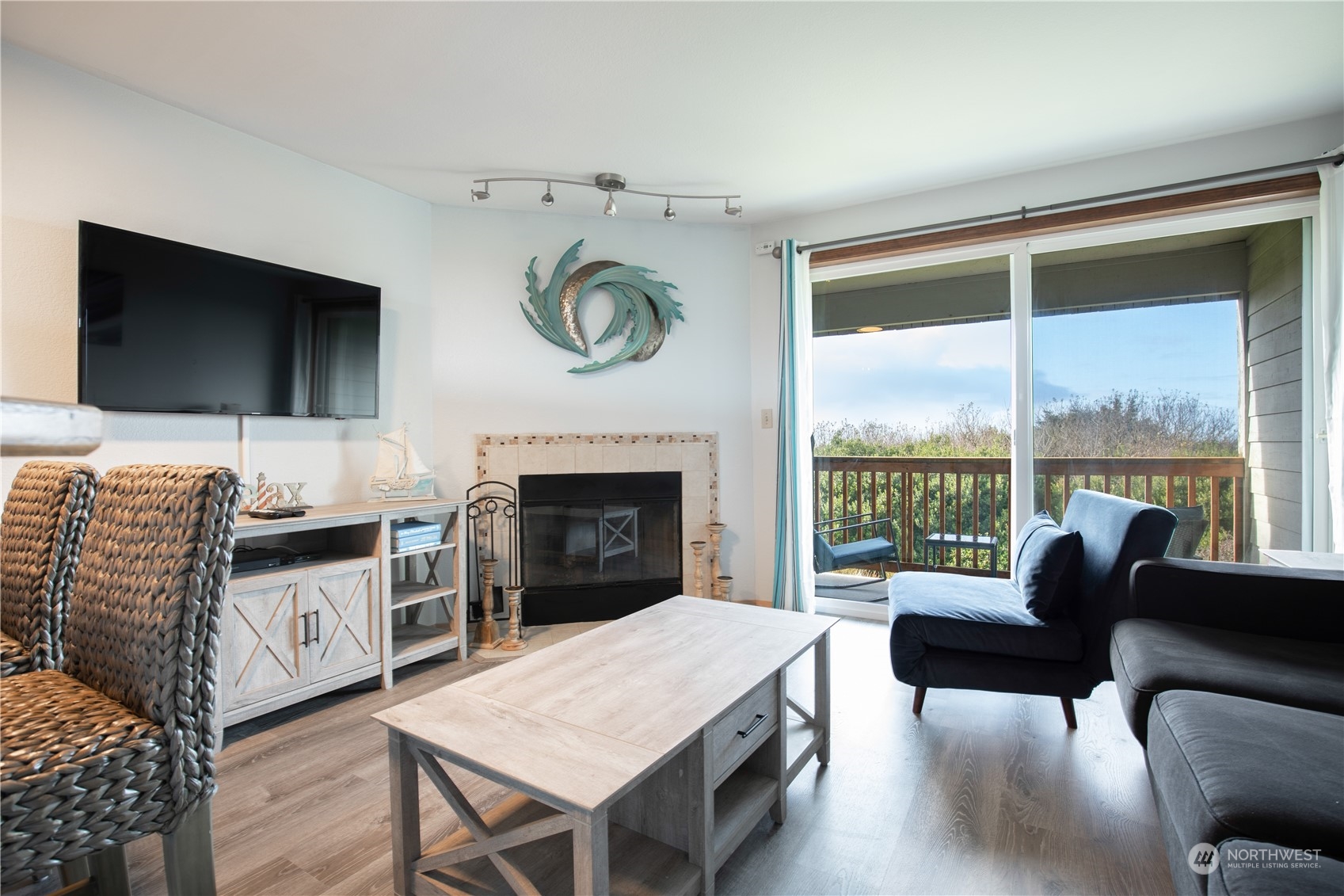 a living room with furniture a flat screen tv and a fireplace