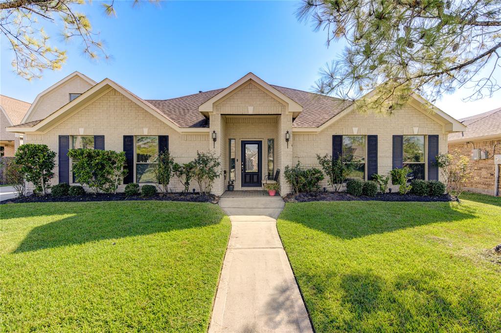 a front view of a house with yard and green space