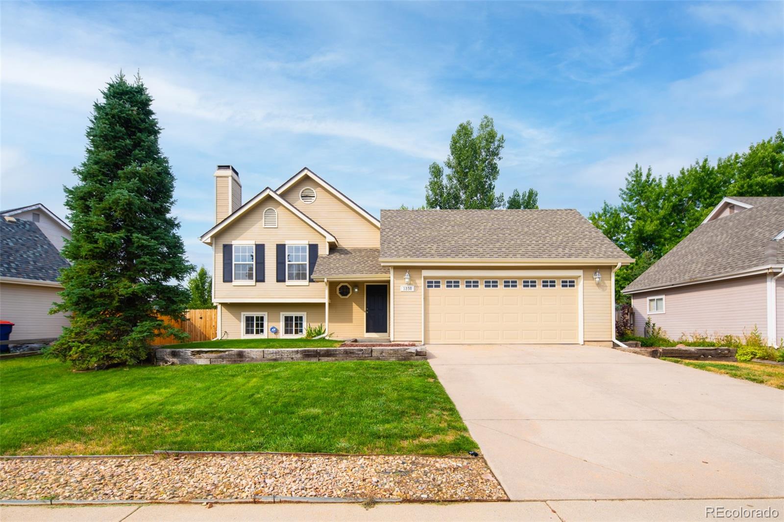 a view of house with a yard