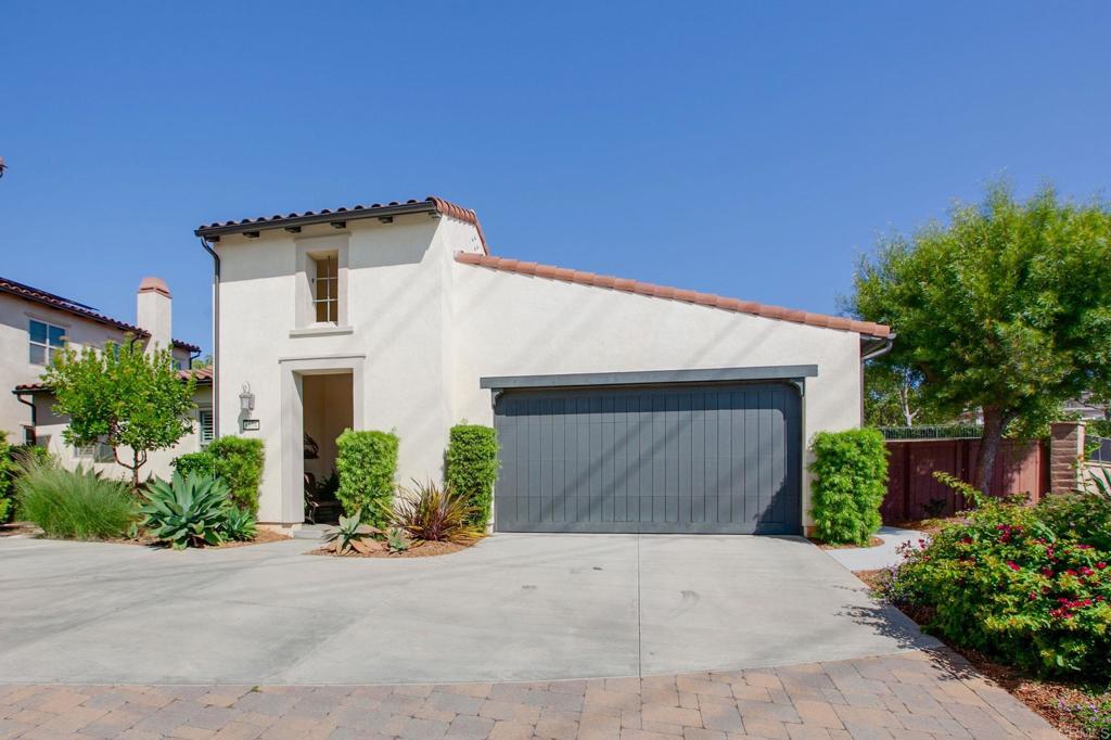 front view of a house with a yard and a garage